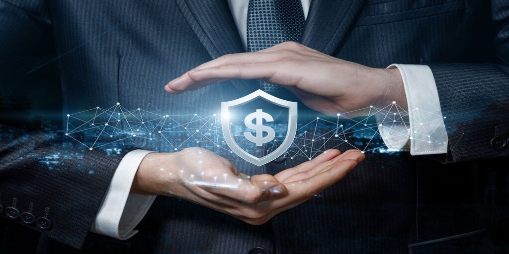 A businessman holds a shield symbol with a dollar sign, representing the protection and management of security guard hiring costs.