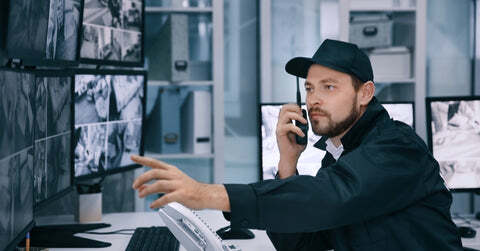 Security guard on the job looking at security cameras