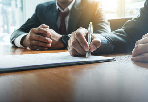 Two businessmen signing a contract