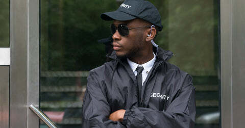 Security guard on patrol with hands folded